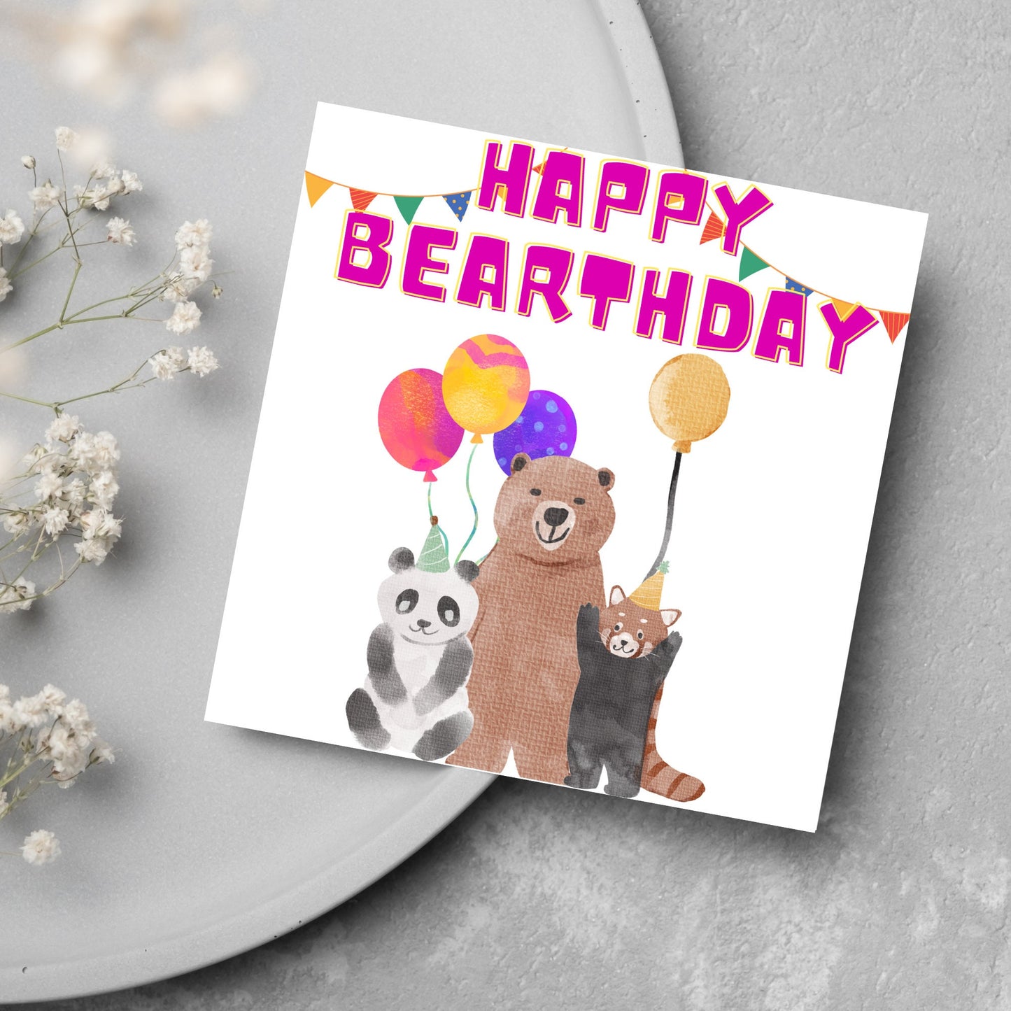 Image of a square Birthday Card. The card has a white background with a vibrant watercolour illustration of 3 bears holding balloons and big pink text that reads happy bearthday, a cute play on the traditional happy birthday.