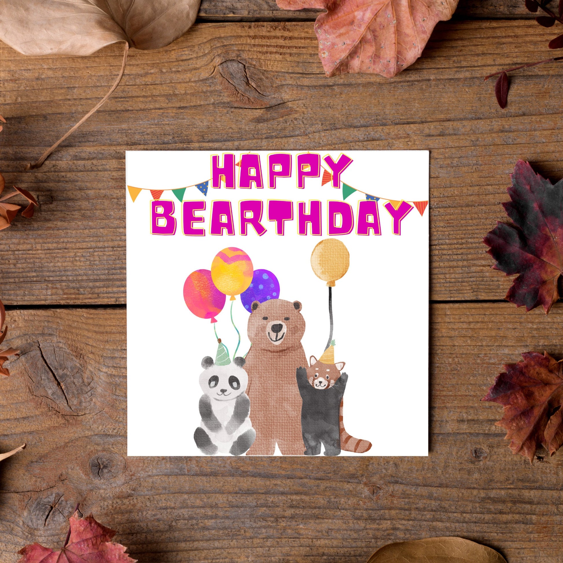 Image of a square Birthday Card. The card has a white background with a vibrant watercolour illustration of 3 bears holding balloons and big pink text that reads happy bearthday, a cute play on the traditional happy birthday.