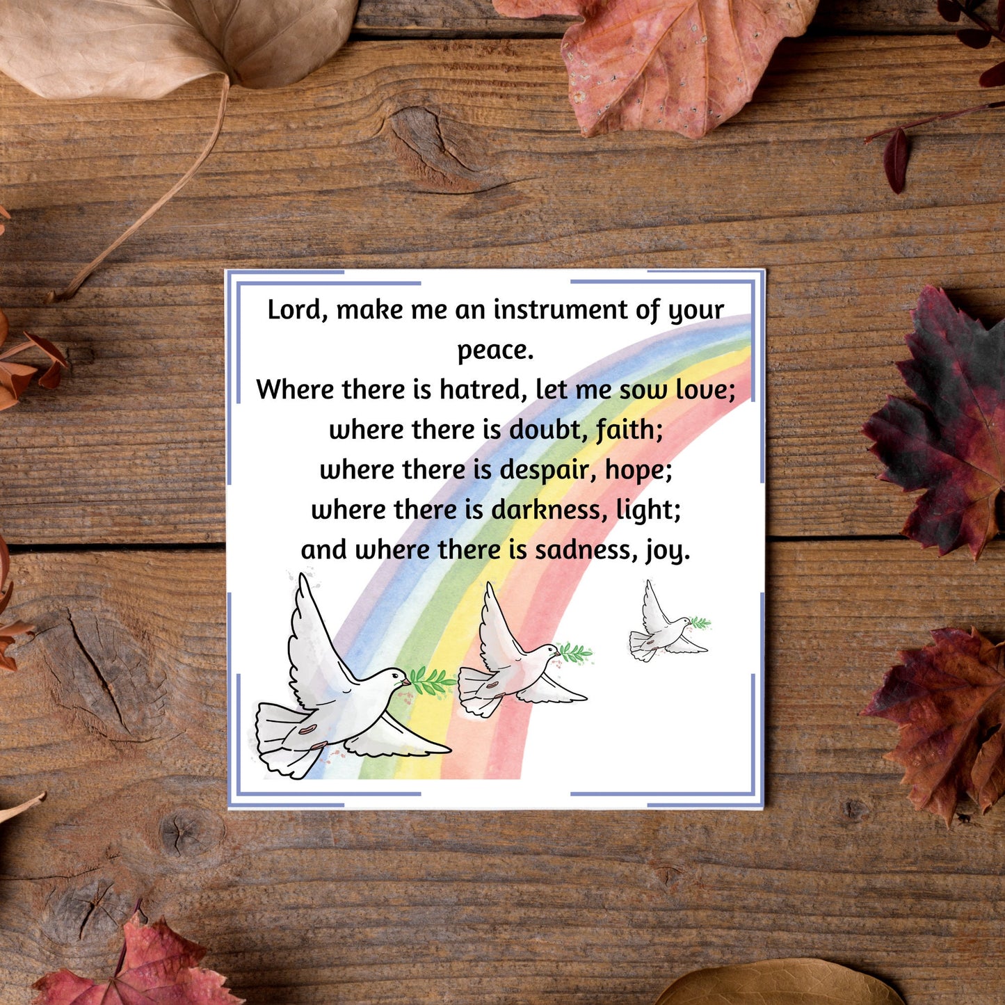 Square greetings card with 3 flying peace doves against a rainbow, with the Prayer of Saint Francis text Lord, make me an instrument of your peace.