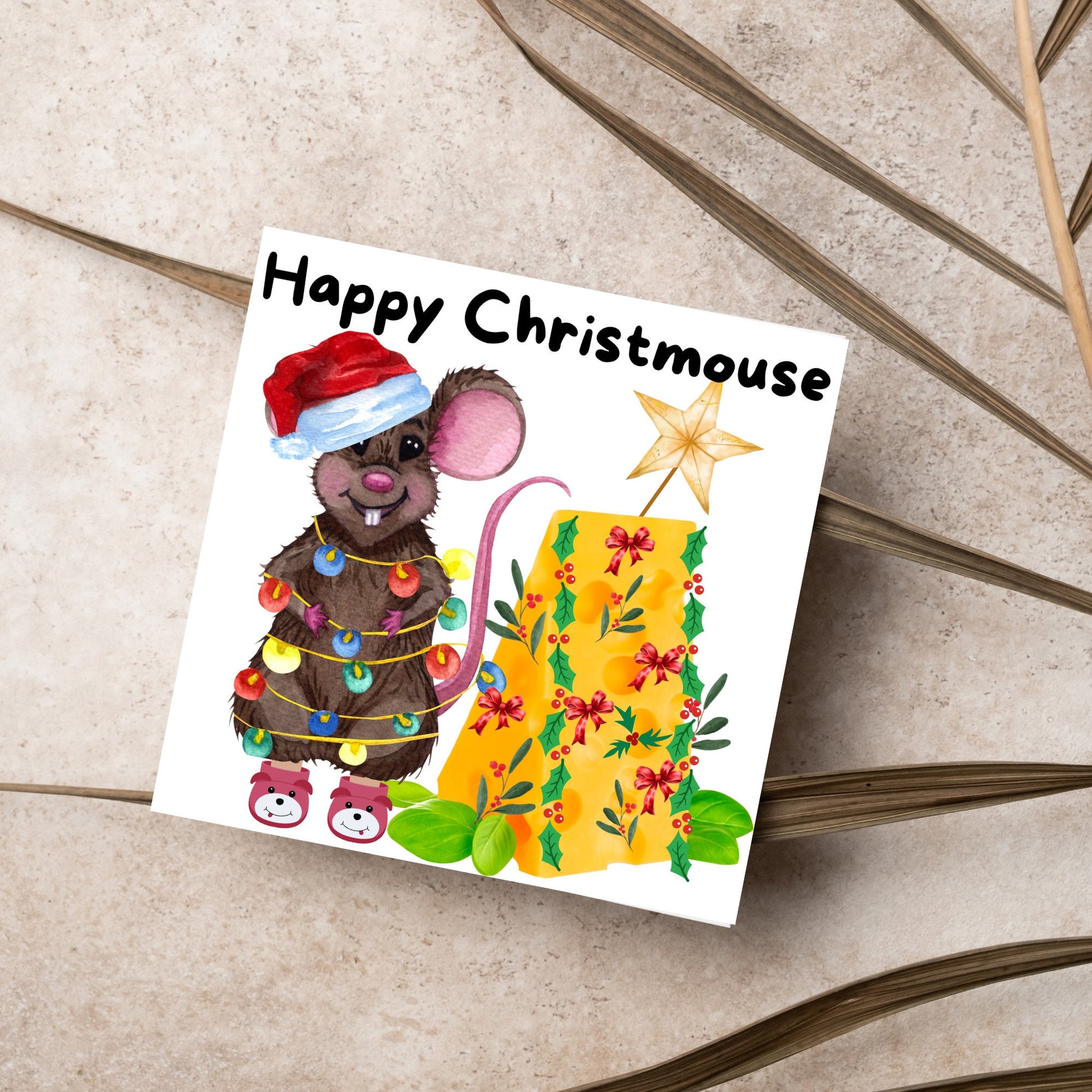 Square Christmas card featuring a cartoon mouse wrapped in christmas lights and wearing a santa hat and slippers next to a christmas tree made from cheese with decorations of holly and red bows. The text, Happy Christmouse is written at the top