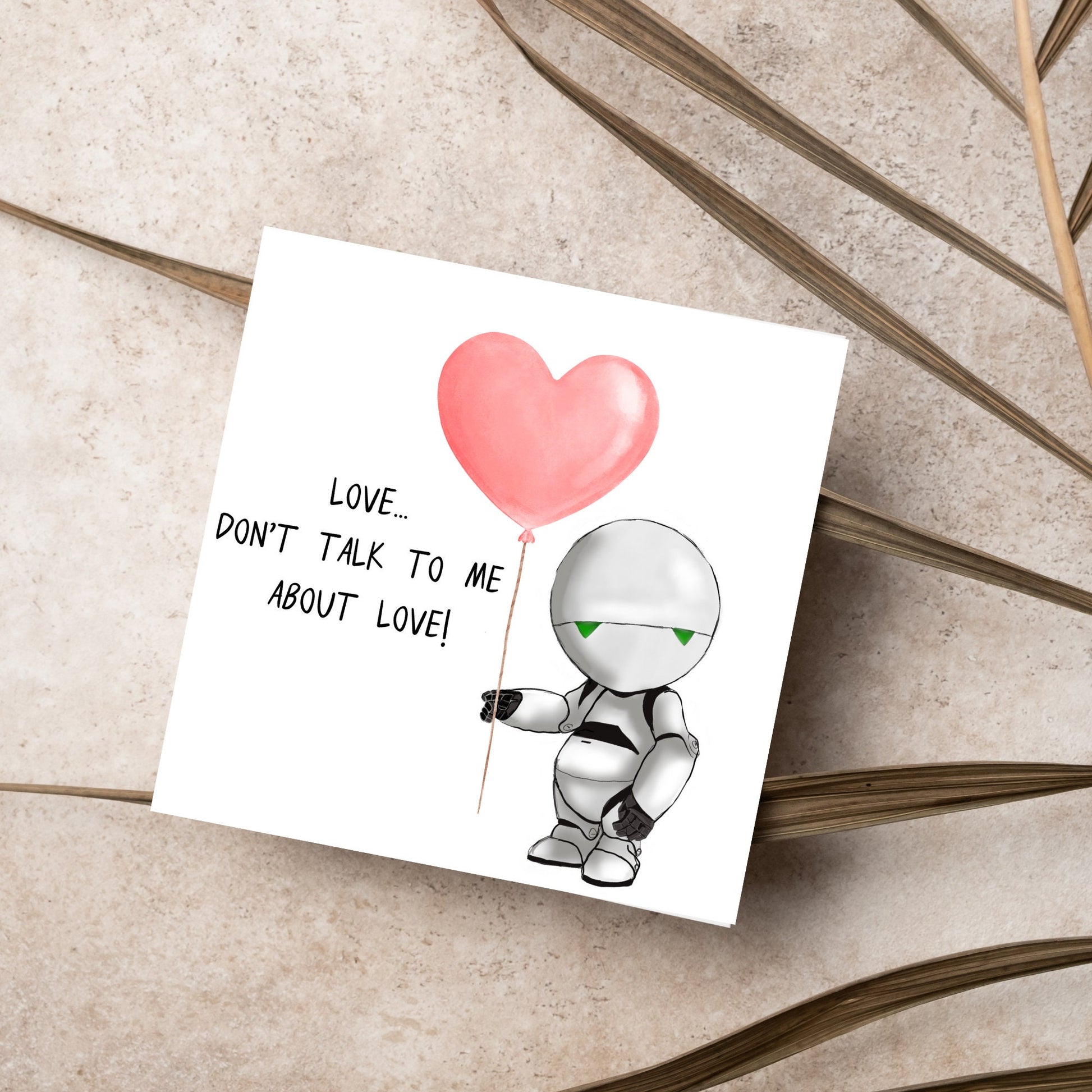 The Square Card has an illistration of Marvin from the classic book, a Hitchhikers guide to the galaxy holding a heart shaped Balloon. It is accompanied by the caption "Love, dont talk to me about Love!"
Funny Love card for boyfriends