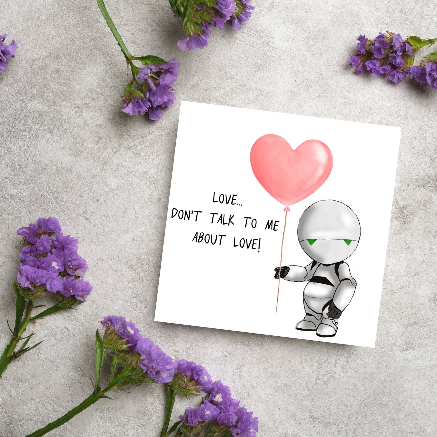 The Square Card has an illistration of Marvin from the classic book, a Hitchhikers guide to the galaxy holding a heart shaped Balloon. It is accompanied by the caption "Love, dont talk to me about Love!"
Funny Love card for boyfriends