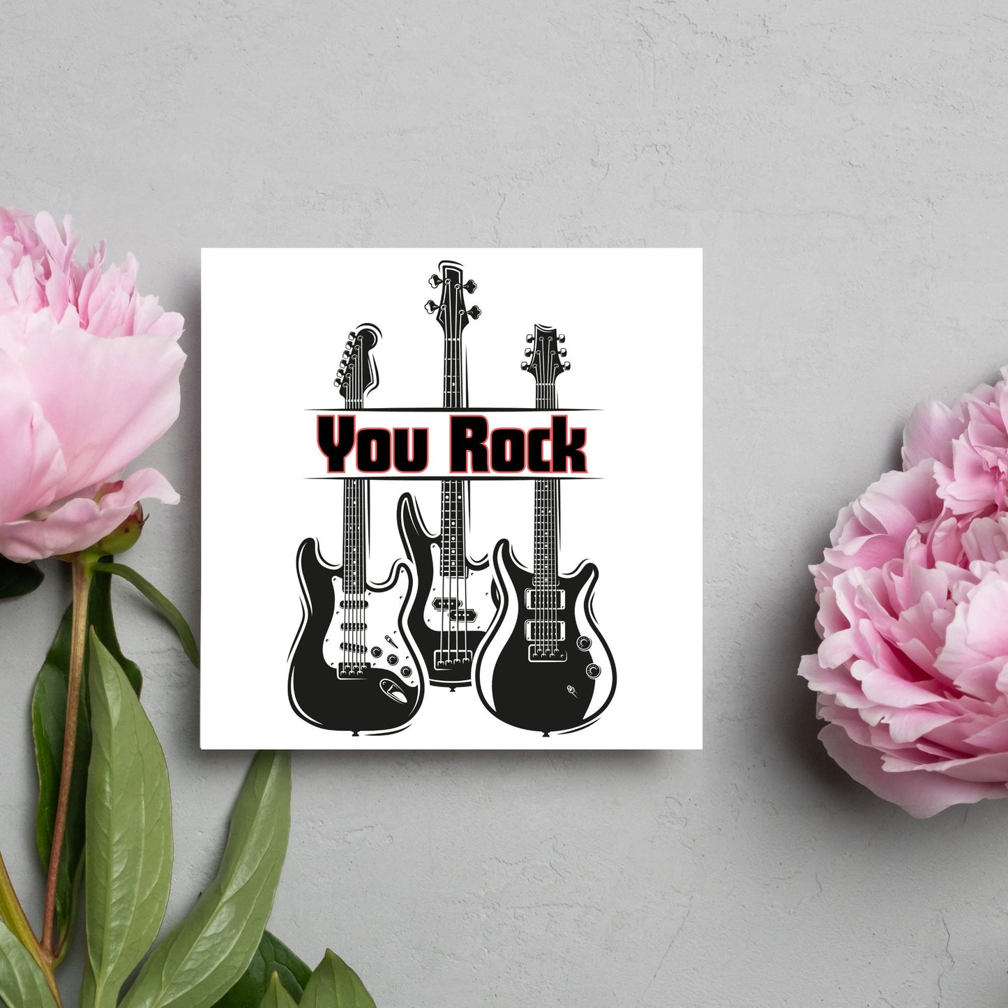 Square Greetings card featuring 3 black electric guitars with 'you rock' written across them in red and black