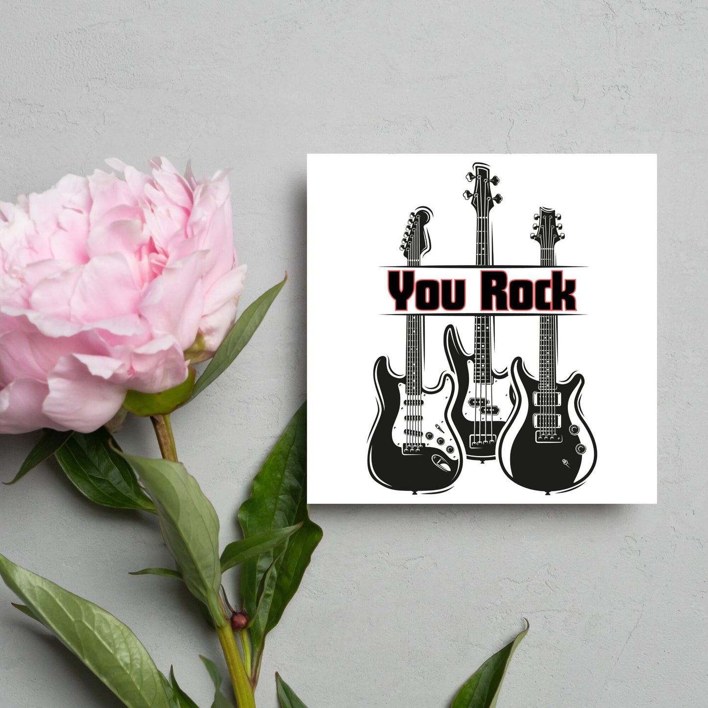 Square Greetings card featuring 3 black electric guitars with 'you rock' written across them in red and black
