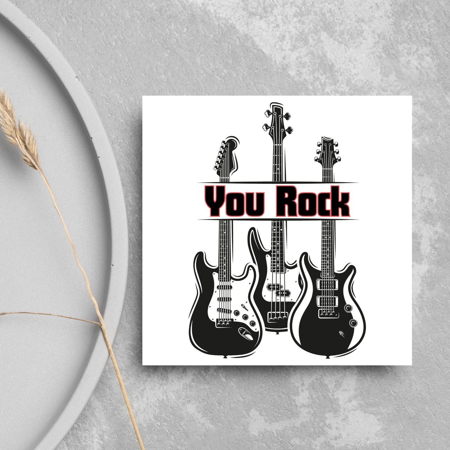 Square Greetings card featuring 3 black electric guitars with 'you rock' written across them in red and black