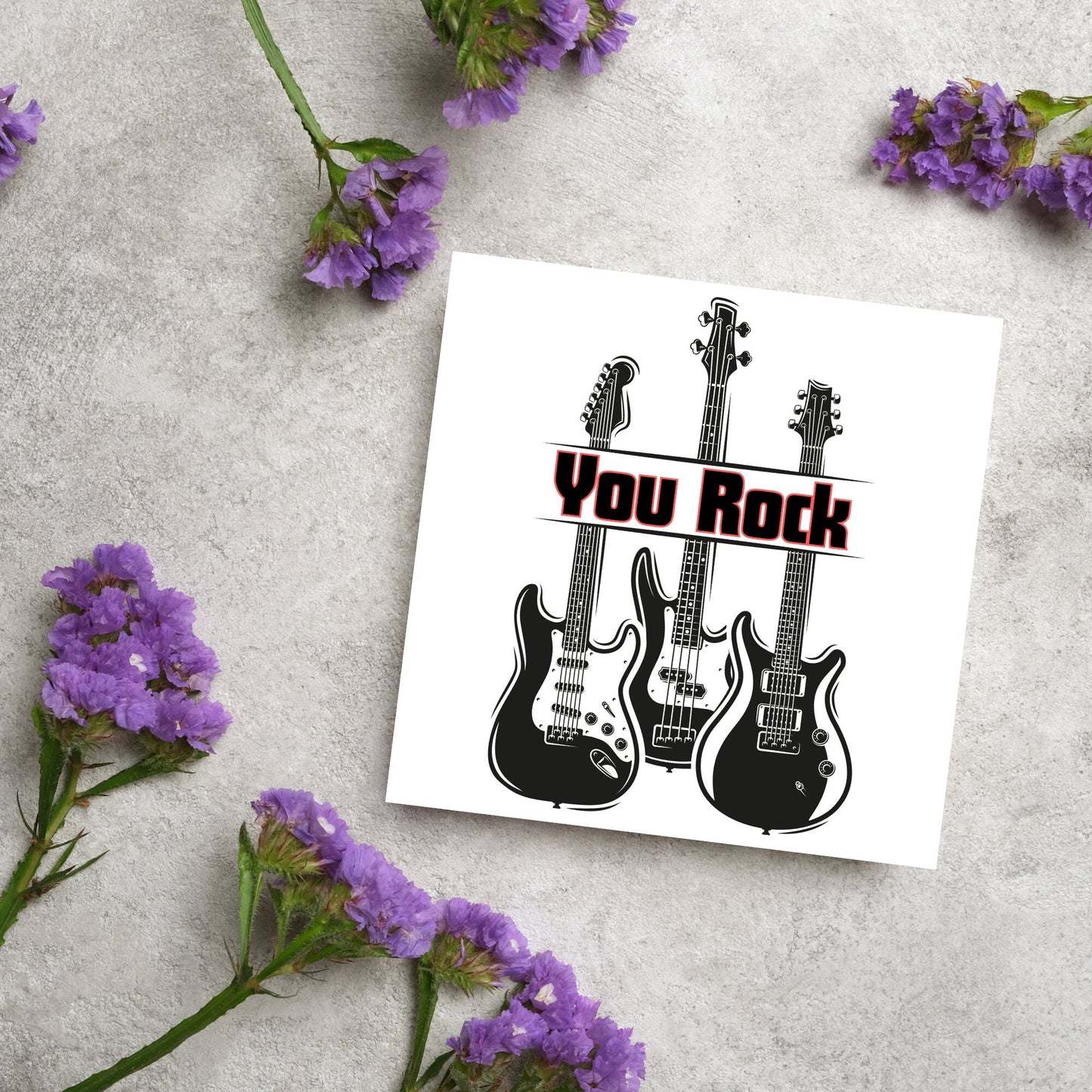 Square Greetings card featuring 3 black electric guitars with 'you rock' written across them in red and black