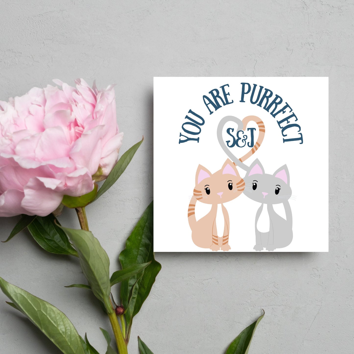 The Square Card has two cute illistration of cats with tails which lock to form a heart shape. Inside the heart is the personalisable initals of your loved one. The card reads 'You are Purrfect'. This anniversary/valentines day card is cute