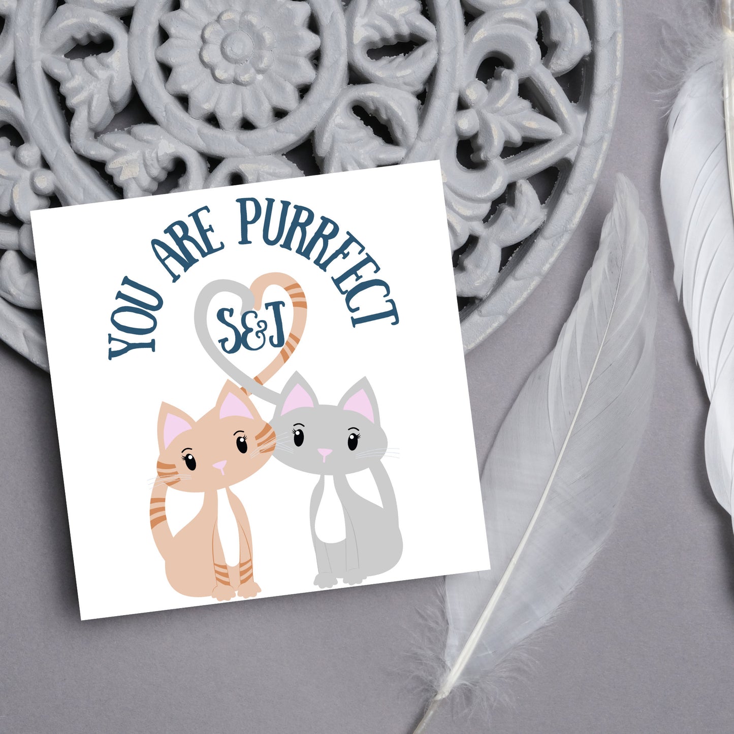 The Square Card has two cute illistration of cats with tails which lock to form a heart shape. Inside the heart is the personalisable initals of your loved one. The card reads 'You are Purrfect'. This anniversary/valentines day card is cute