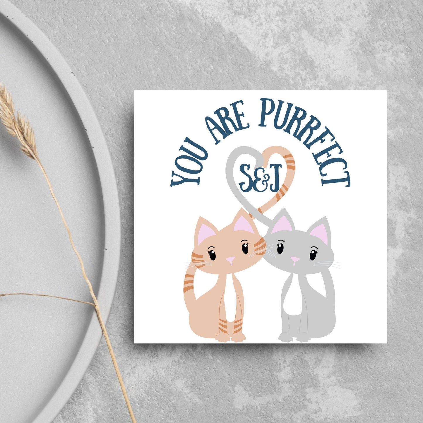 The Square Card has two cute illistration of cats with tails which lock to form a heart shape. Inside the heart is the personalisable initals of your loved one. The card reads 'You are Purrfect'. This anniversary/valentines day card is cute