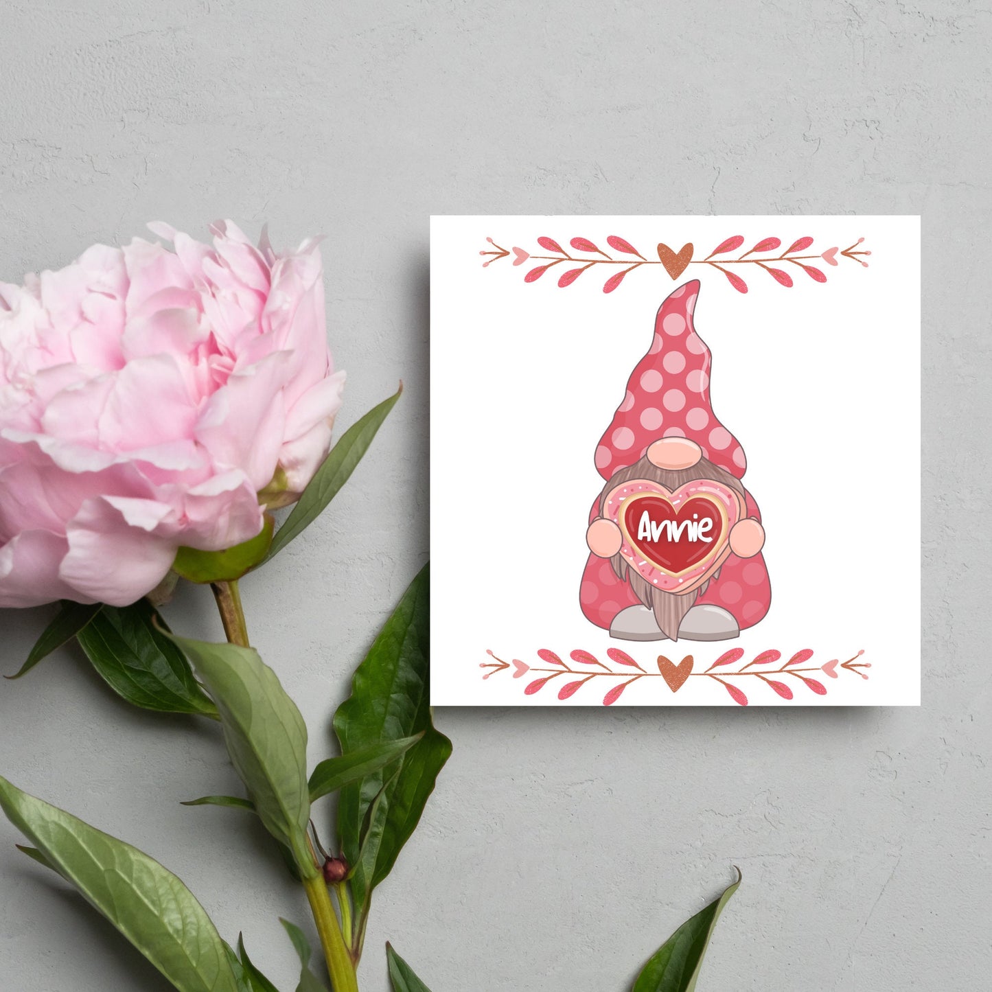 The Square Card has a cute gonk holding a love heart with a perssonalised name, the card has a cute heart header and footer, The Card is a cute representation of love, The Card is perfect for your valentines