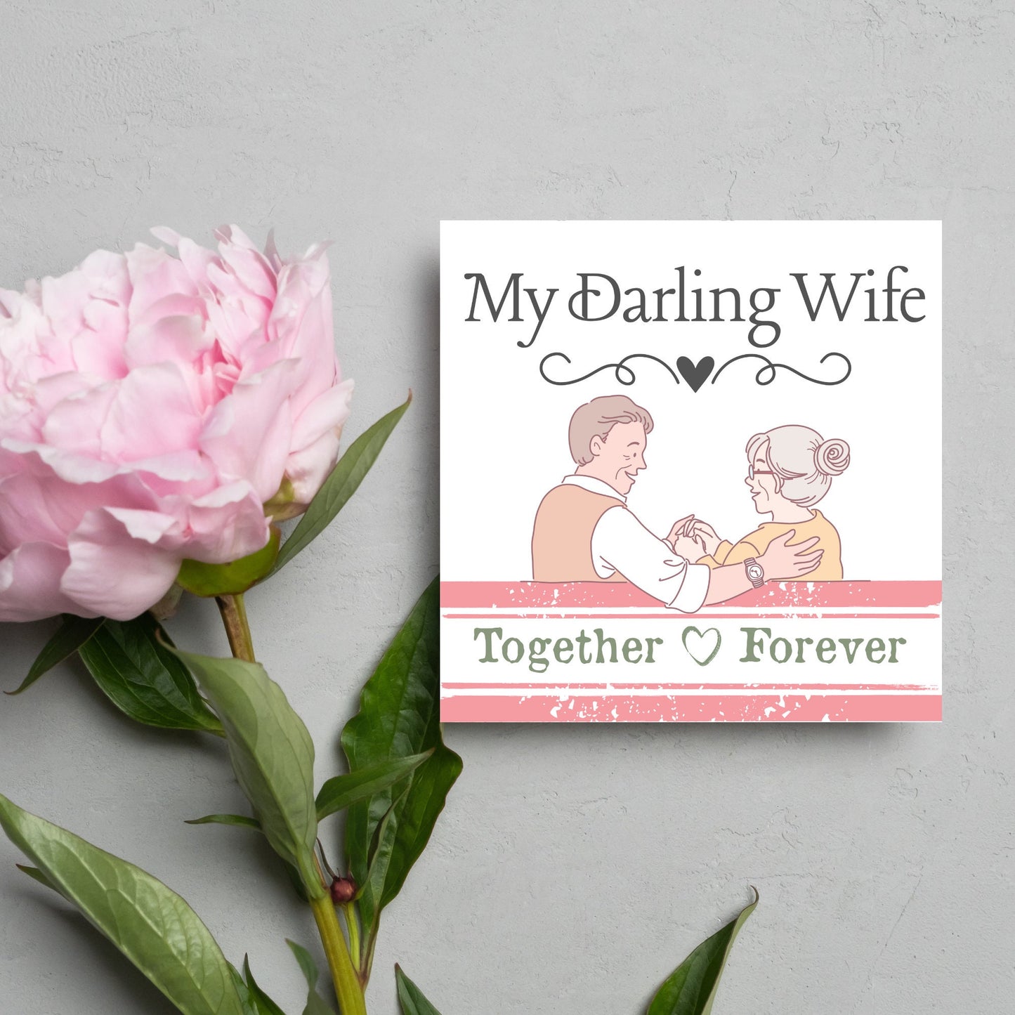 The Card has an illistration of a married couple holding hands. The Caption Reads 'My Darling Wife - Together Forever'. The Card is printed in pastel tones and is perfect for anniversaries or valentines day.