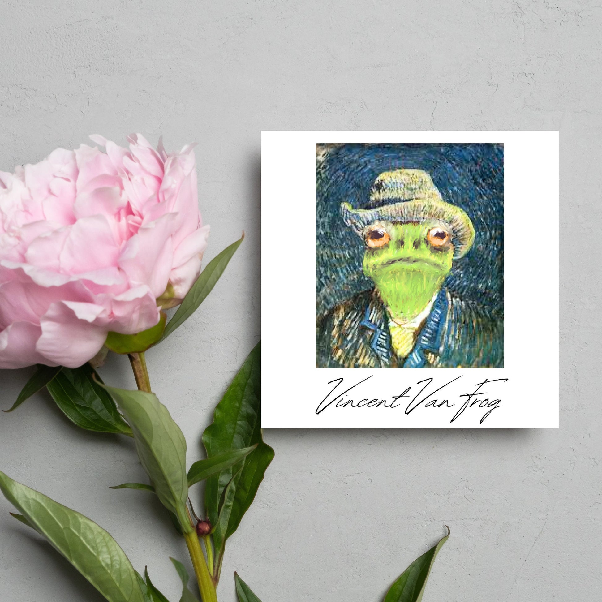 Image of a square greetings card with a remake of Vincent Van Gogh's famous self portrait but redone into a frog face. Underneath the painting the text reads Vincent Van Frog in a signature style