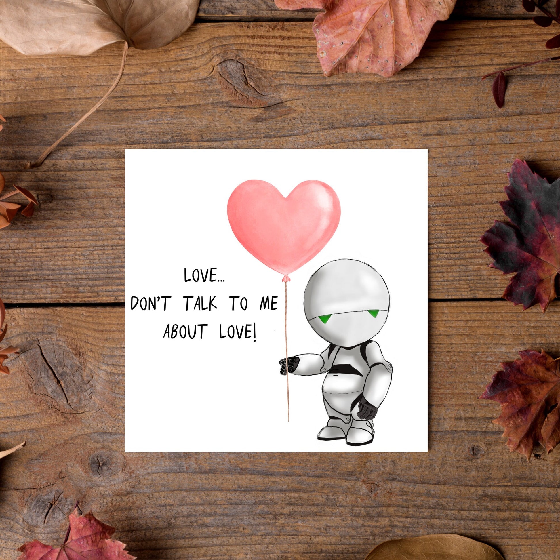 The Square Card has an illistration of Marvin from the classic book, a Hitchhikers guide to the galaxy holding a heart shaped Balloon. It is accompanied by the caption "Love, dont talk to me about Love!"
Funny Love card for boyfriends