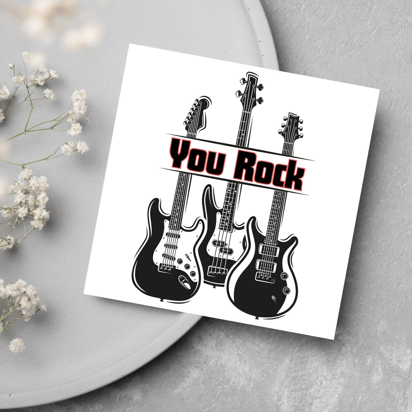 Square Greetings card featuring 3 black electric guitars with 'you rock' written across them in red and black