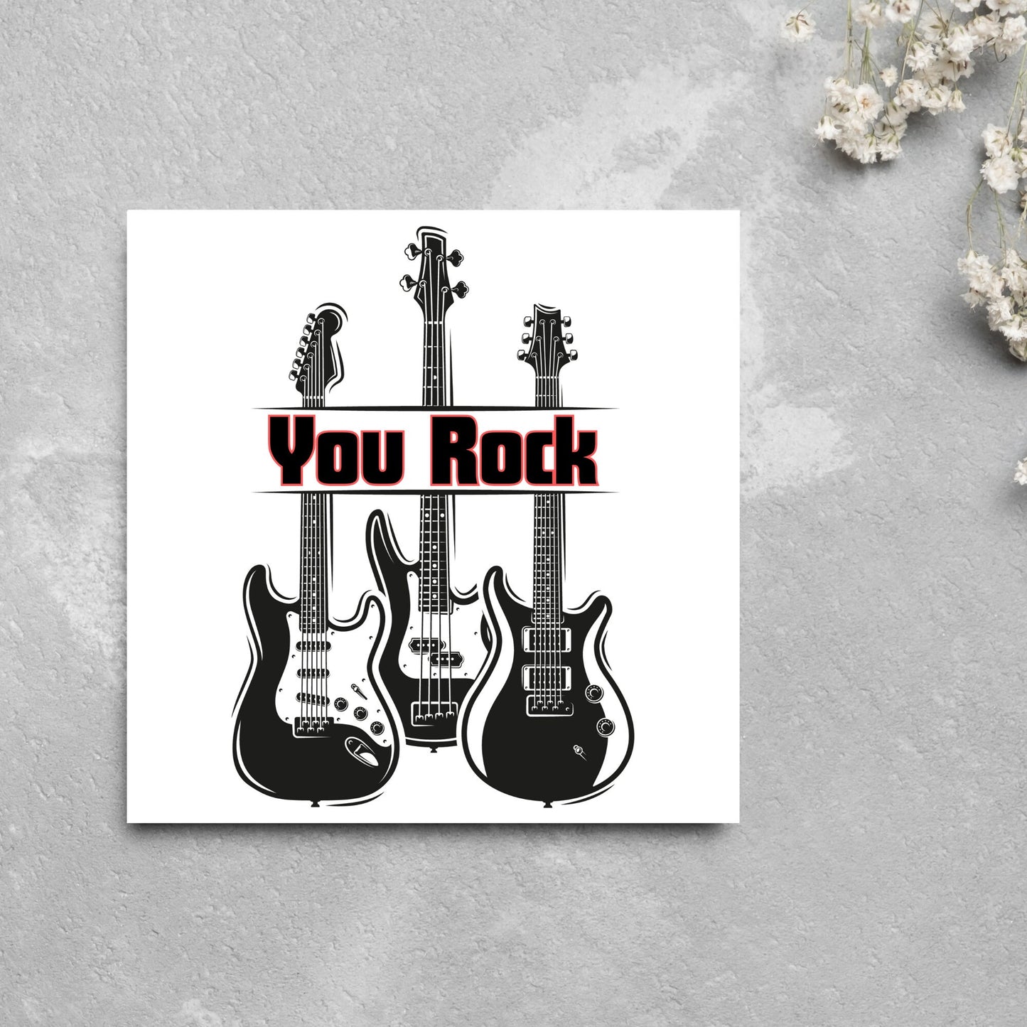Square Greetings card featuring 3 black electric guitars with 'you rock' written across them in red and black