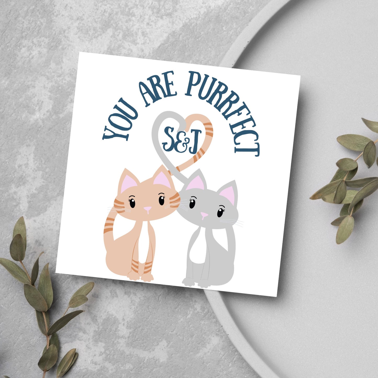 The Square Card has two cute illistration of cats with tails which lock to form a heart shape. Inside the heart is the personalisable initals of your loved one. The card reads 'You are Purrfect'. This anniversary/valentines day card is cute
