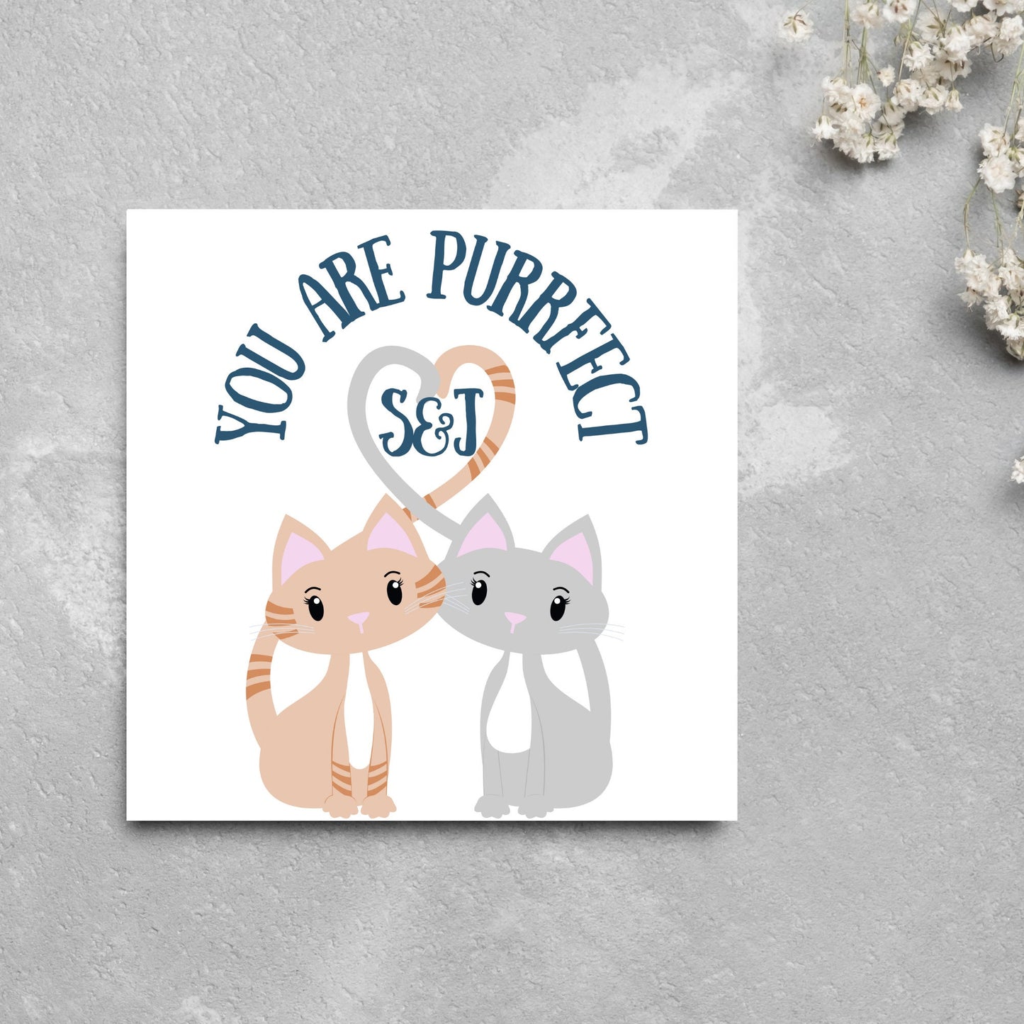 The Square Card has two cute illistration of cats with tails which lock to form a heart shape. Inside the heart is the personalisable initals of your loved one. The card reads 'You are Purrfect'. This anniversary/valentines day card is cute