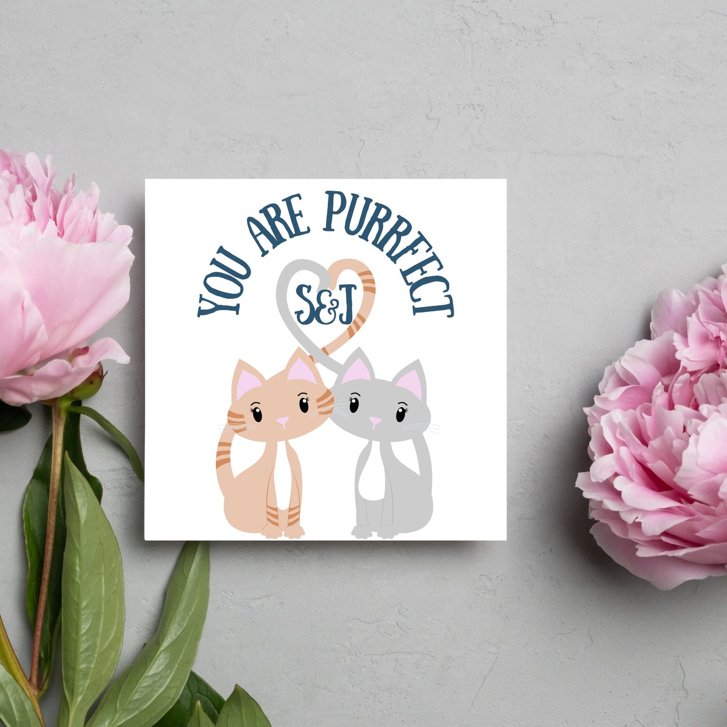 The Square Card has two cute illistration of cats with tails which lock to form a heart shape. Inside the heart is the personalisable initals of your loved one. The card reads 'You are Purrfect'. This anniversary/valentines day card is cute