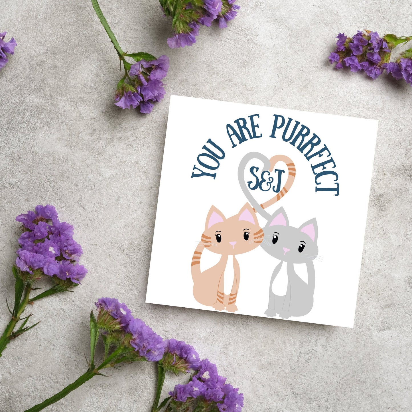 The Square Card has two cute illistration of cats with tails which lock to form a heart shape. Inside the heart is the personalisable initals of your loved one. The card reads 'You are Purrfect'. This anniversary/valentines day card is cute
