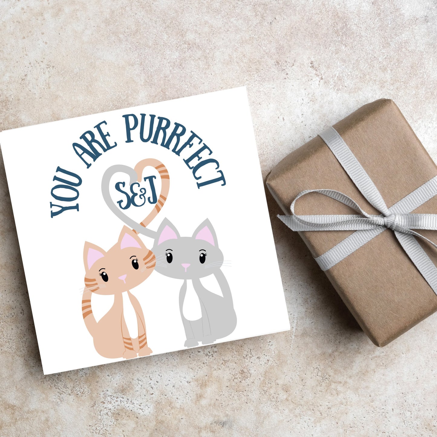 The Square Card has two cute illistration of cats with tails which lock to form a heart shape. Inside the heart is the personalisable initals of your loved one. The card reads 'You are Purrfect'. This anniversary/valentines day card is cute