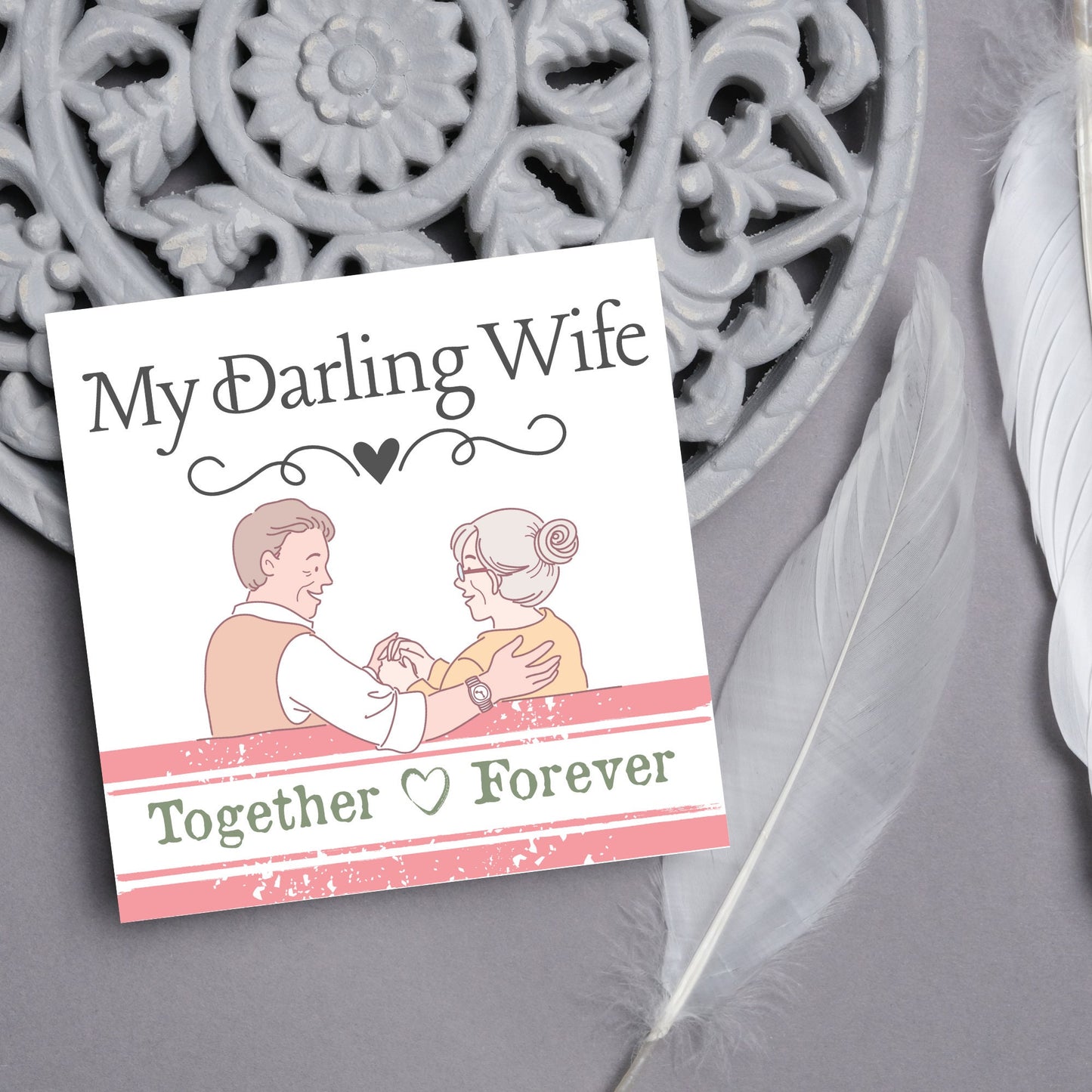 The Card has an illistration of a married couple holding hands. The Caption Reads 'My Darling Wife - Together Forever'. The Card is printed in pastel tones and is perfect for anniversaries or valentines day.