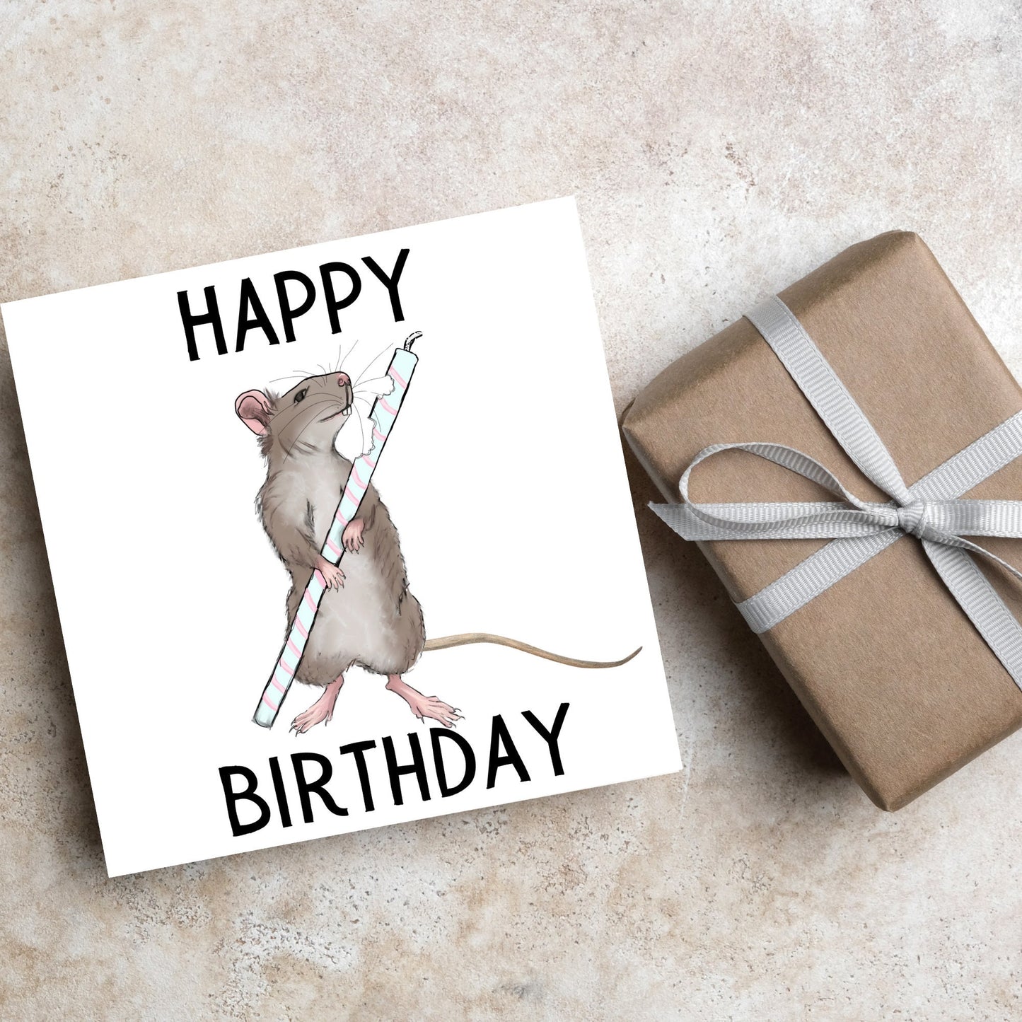rat holding a half chewed birthday candle