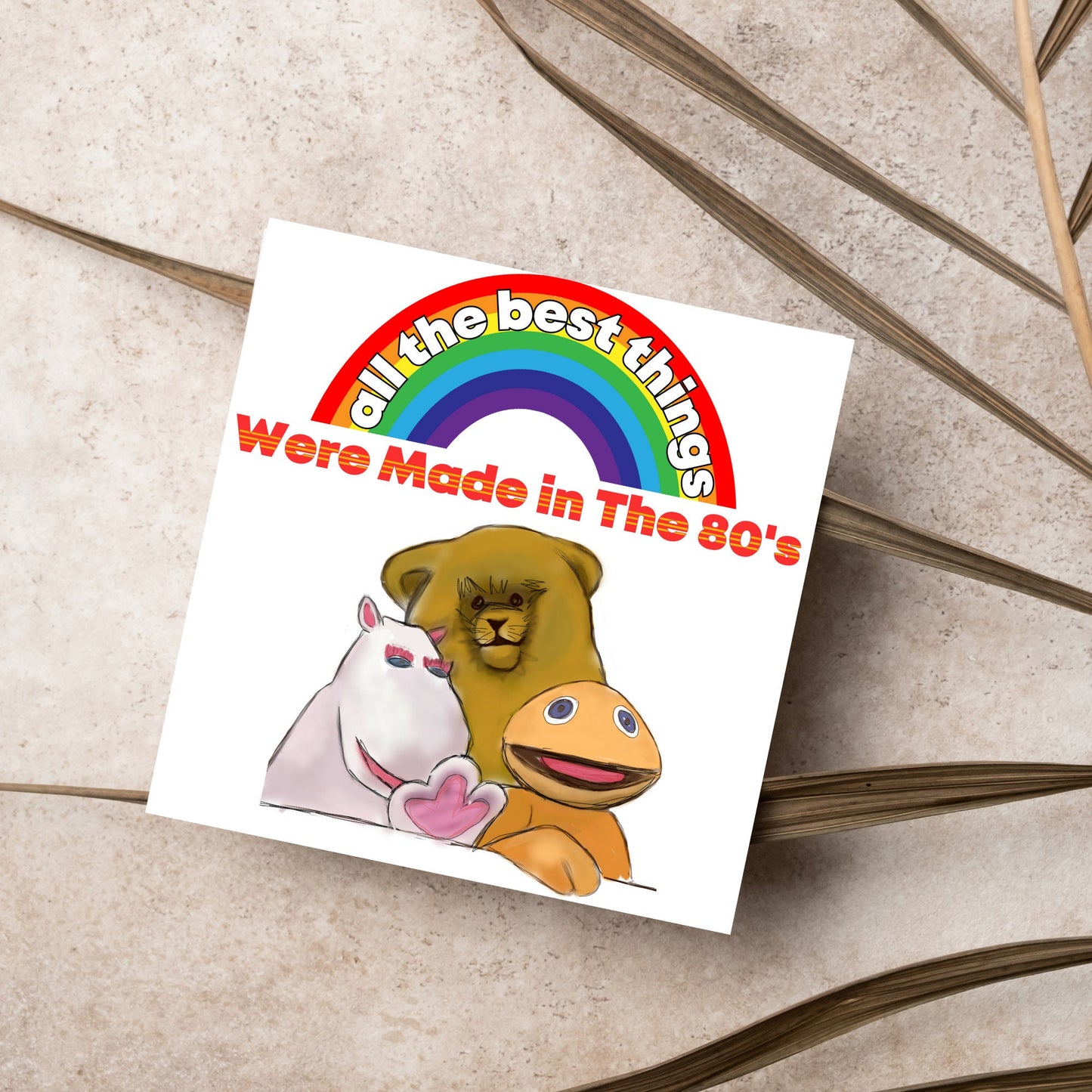 square card featuring an illustration of the characters from the tv show rainbow with a rainbow and red text that reads 'all the best things were' made in the 80's' in the font from the shows title