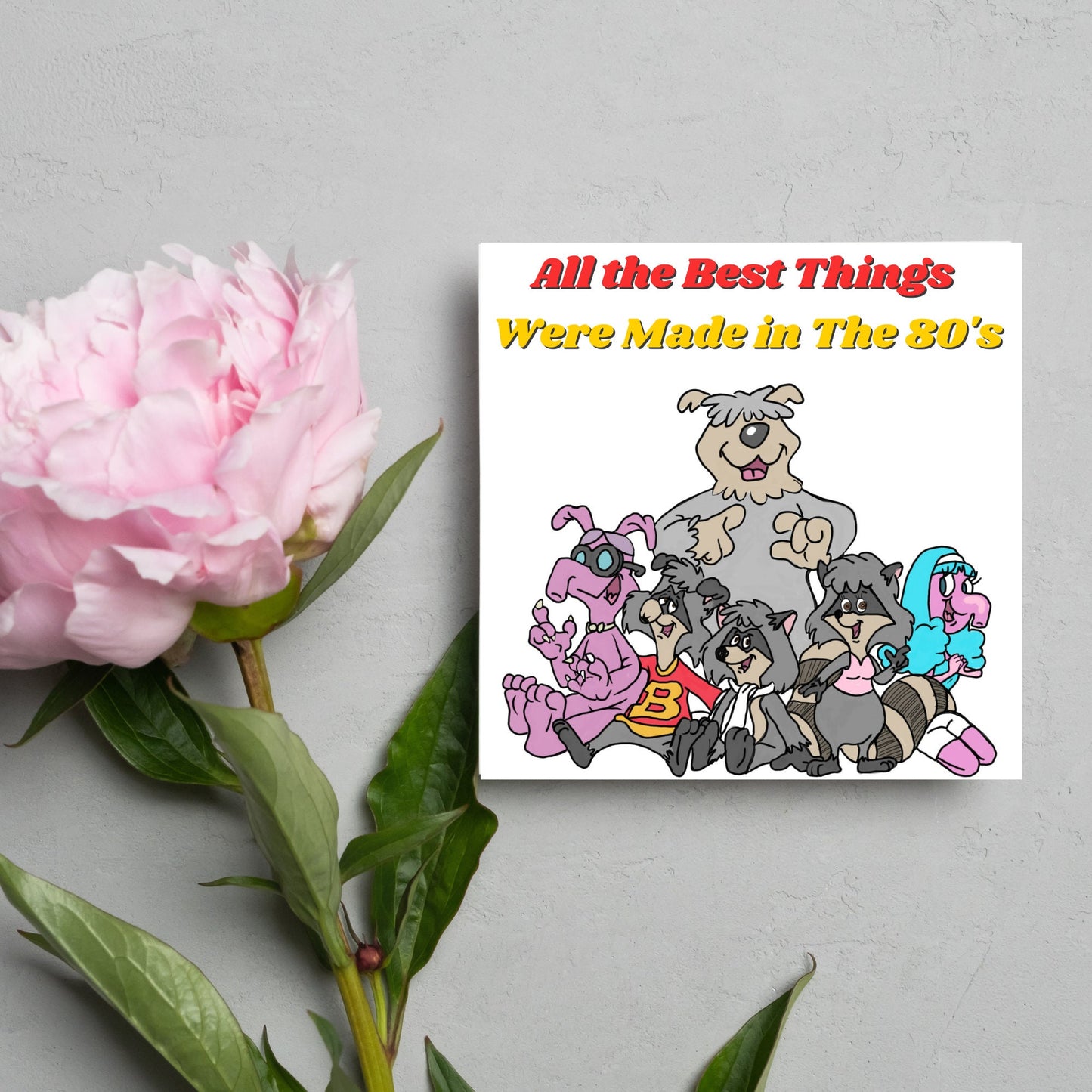 square card featuring an illustration of the raccoons from the tv cartoon with yellow and red text that reads 'all the best things were' made in the 80's' in the font from the shows title