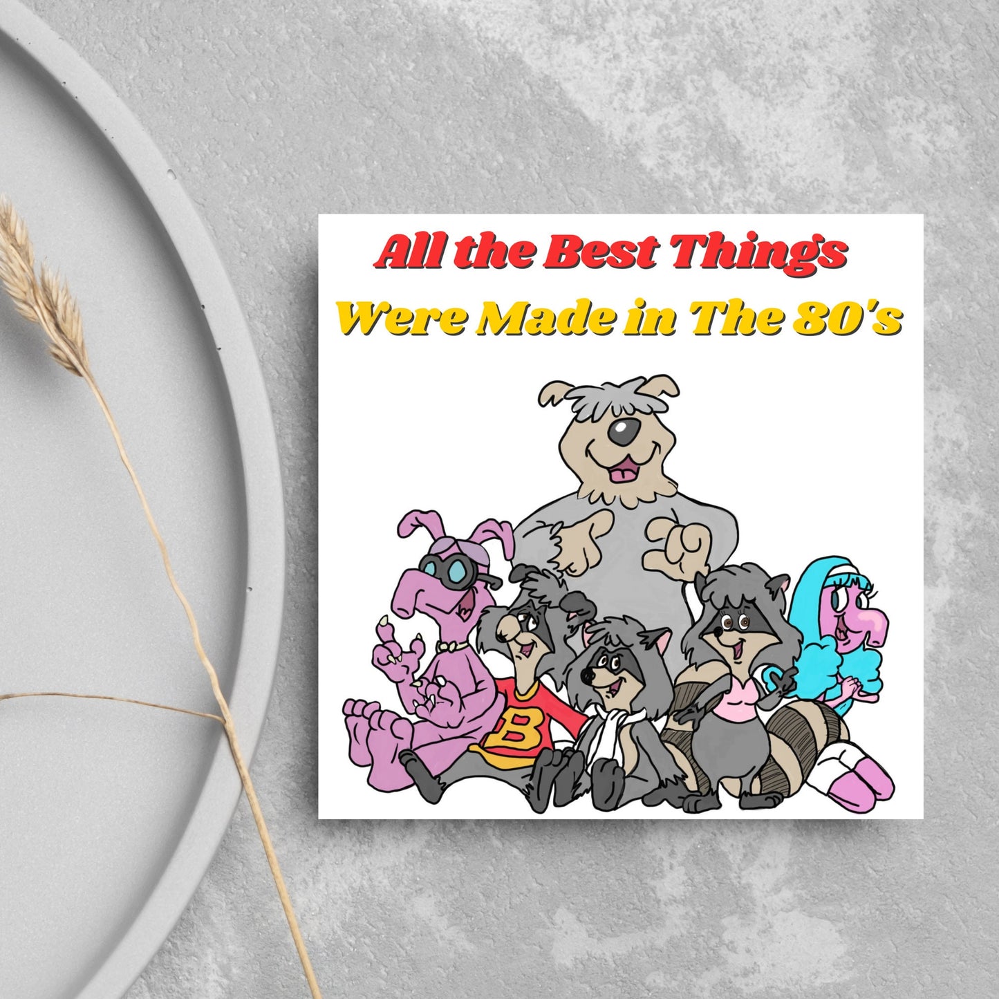 square card featuring an illustration of the raccoons from the tv cartoon with yellow and red text that reads 'all the best things were' made in the 80's' in the font from the shows title