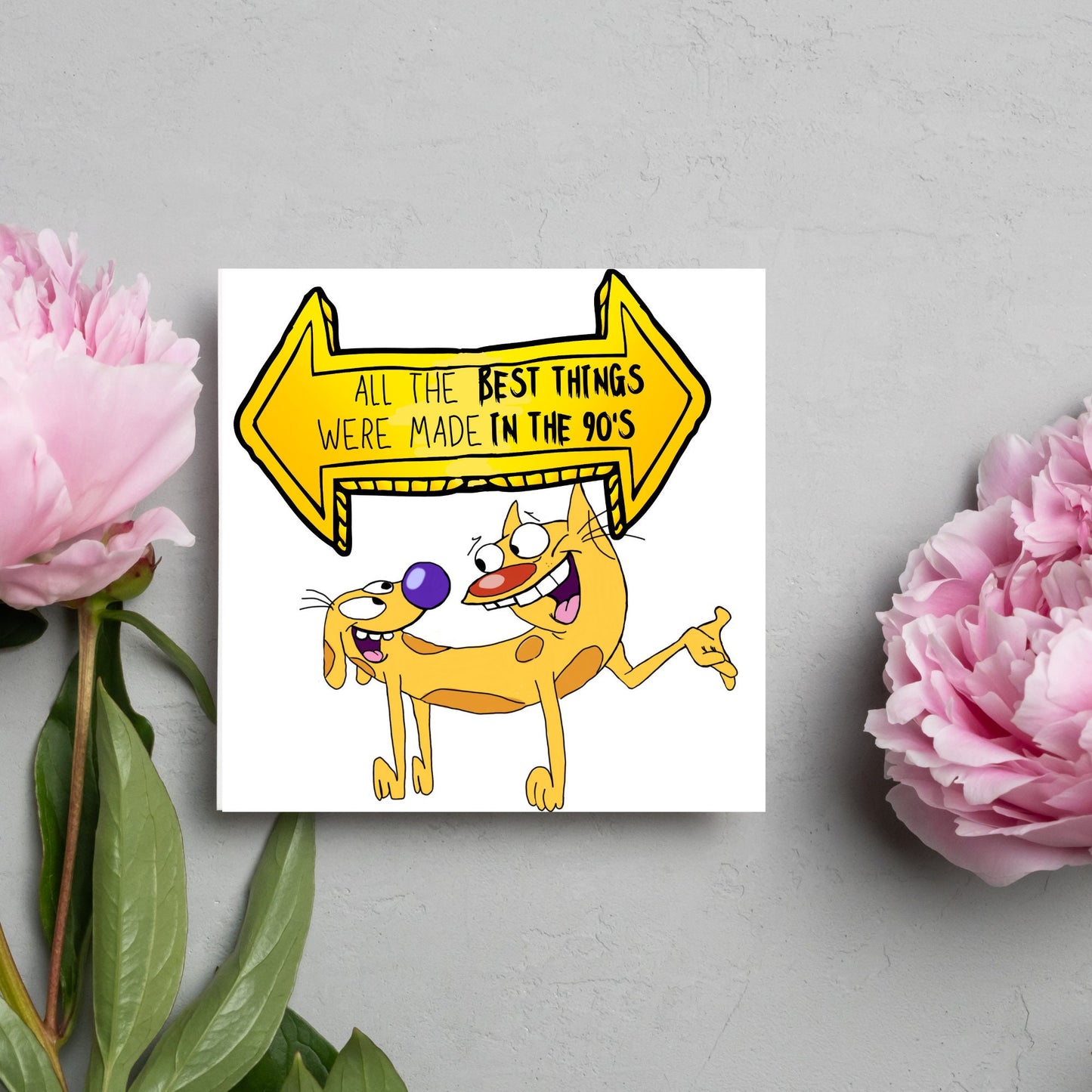 square card featuring an illustration of catdog with a yellow and black sign above them with the text that reads 'all the best things were' made in the 90's' in the font from the shows title