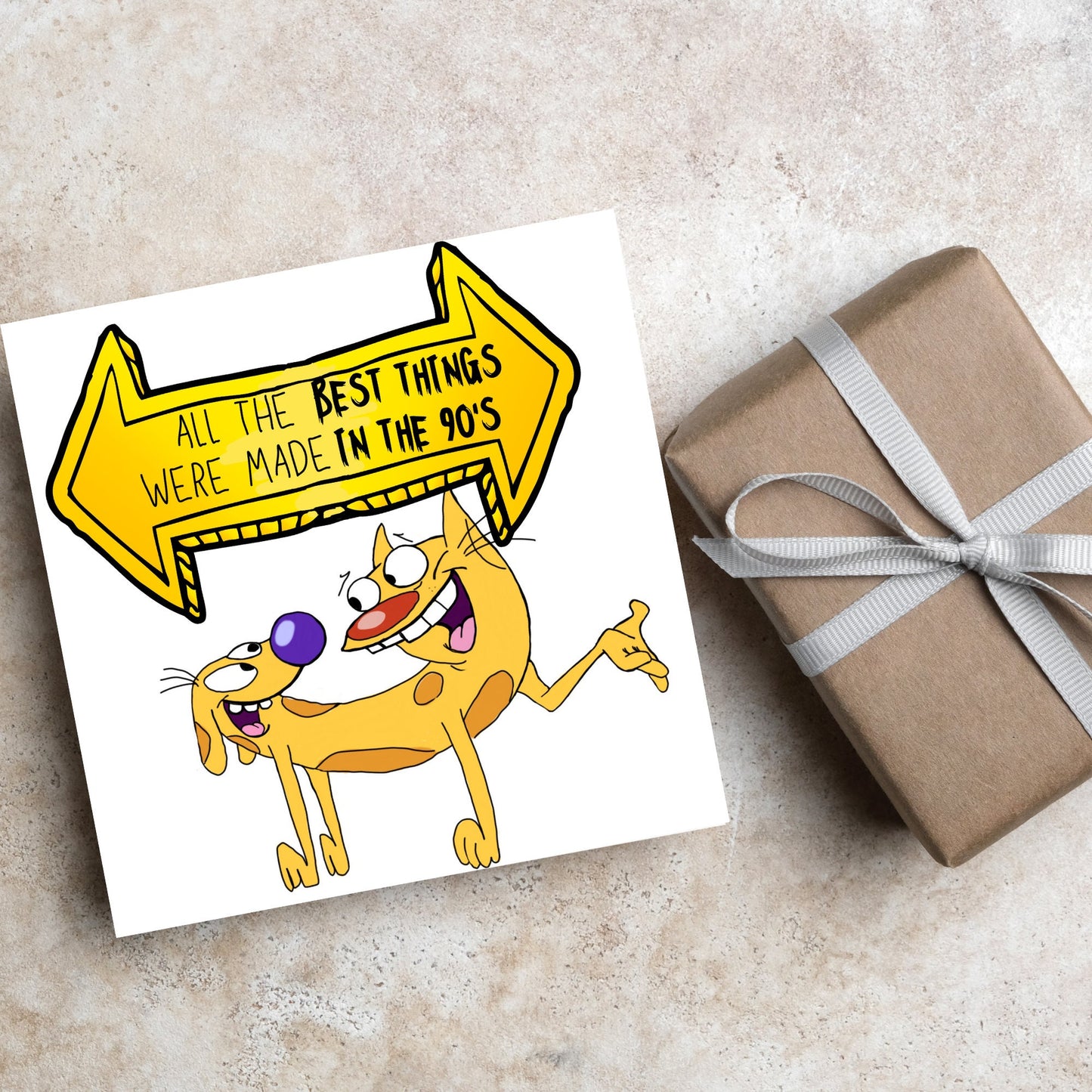 square card featuring an illustration of catdog with a yellow and black sign above them with the text that reads 'all the best things were' made in the 90's' in the font from the shows title