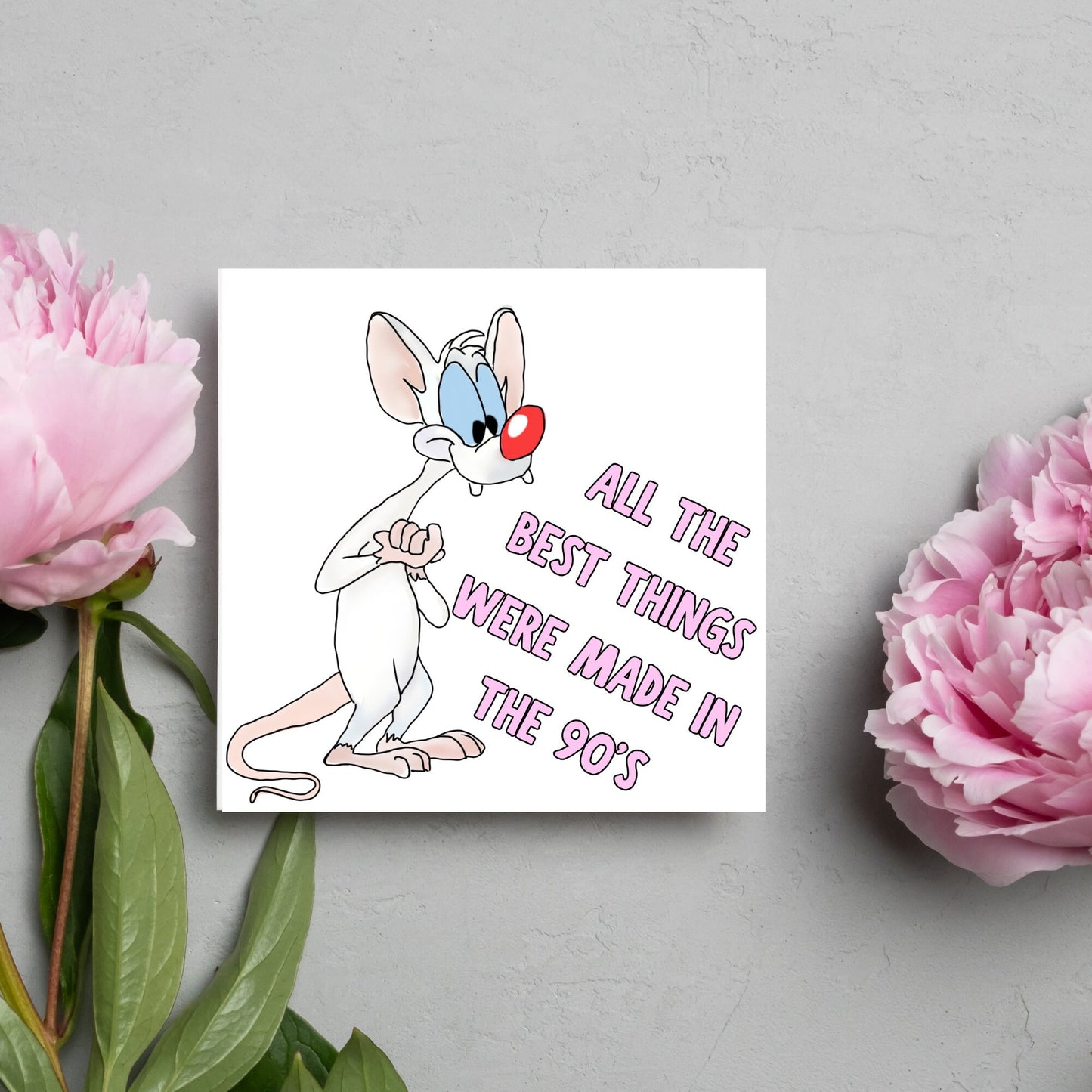 square card featuring an illustration of Pinky from Pinky and the brain with pink text text that reads 'all the best things were' made in the 90's' in the font from the shows title