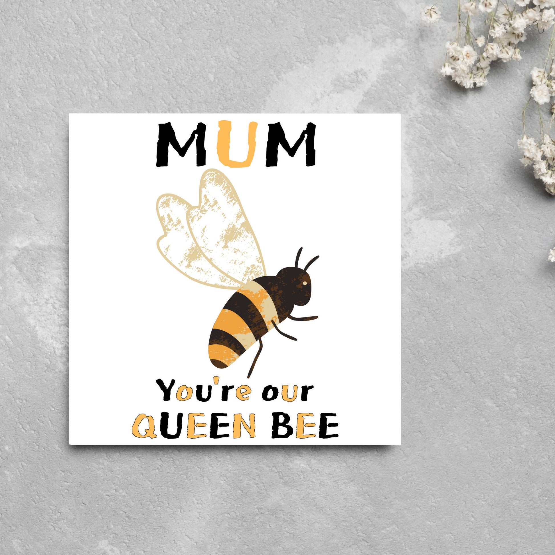 square Birthday card with a watercolour illustration of a bee in the centre and yellow and black text which reads , mum youre our queen bee, in a textured style font resembling pollen