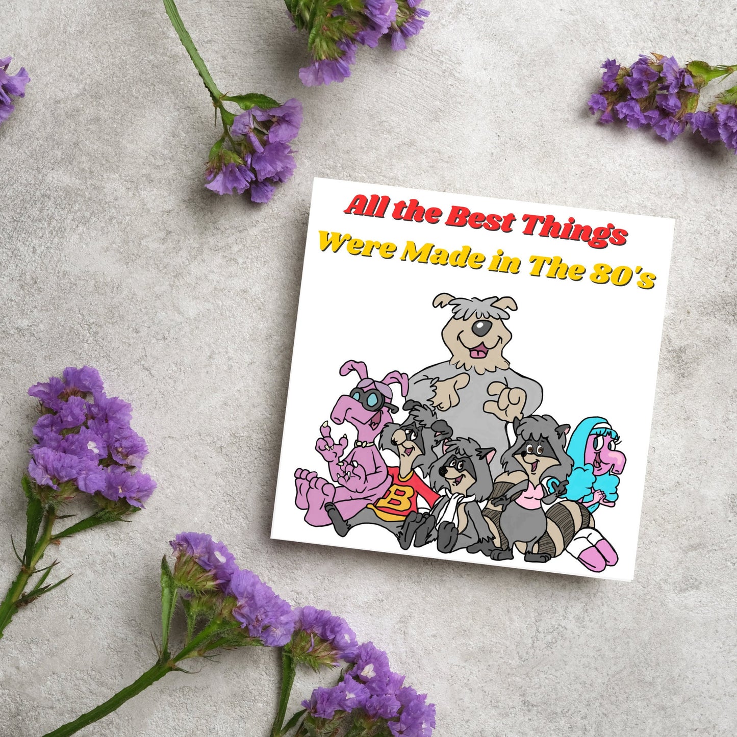 square card featuring an illustration of the raccoons from the tv cartoon with yellow and red text that reads 'all the best things were' made in the 80's' in the font from the shows title