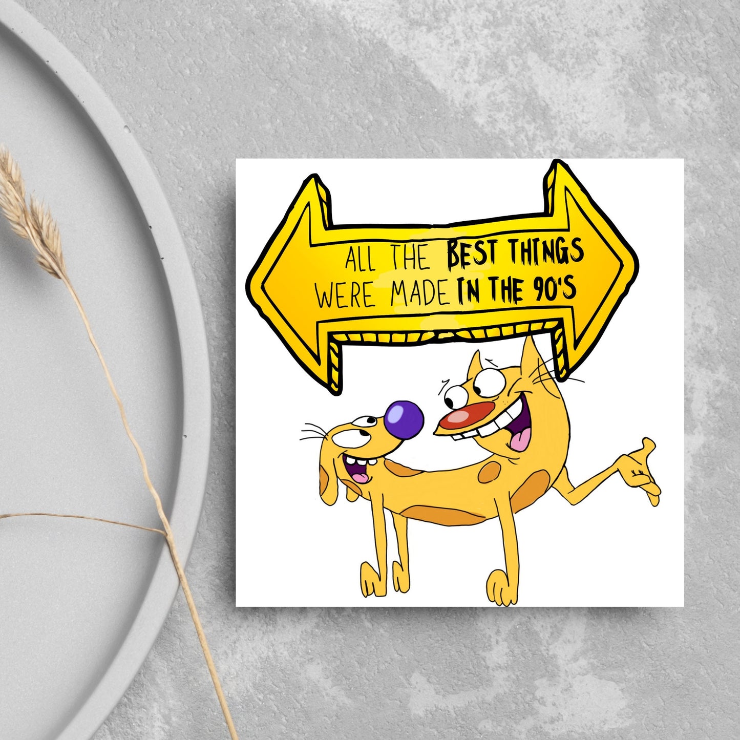 square card featuring an illustration of catdog with a yellow and black sign above them with the text that reads 'all the best things were' made in the 90's' in the font from the shows title