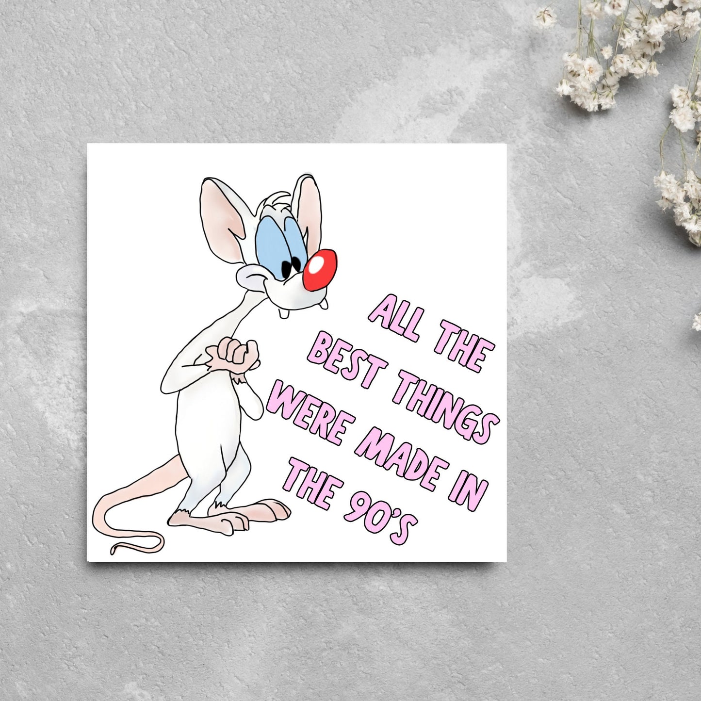 square card featuring an illustration of Pinky from Pinky and the brain with pink text text that reads 'all the best things were' made in the 90's' in the font from the shows title