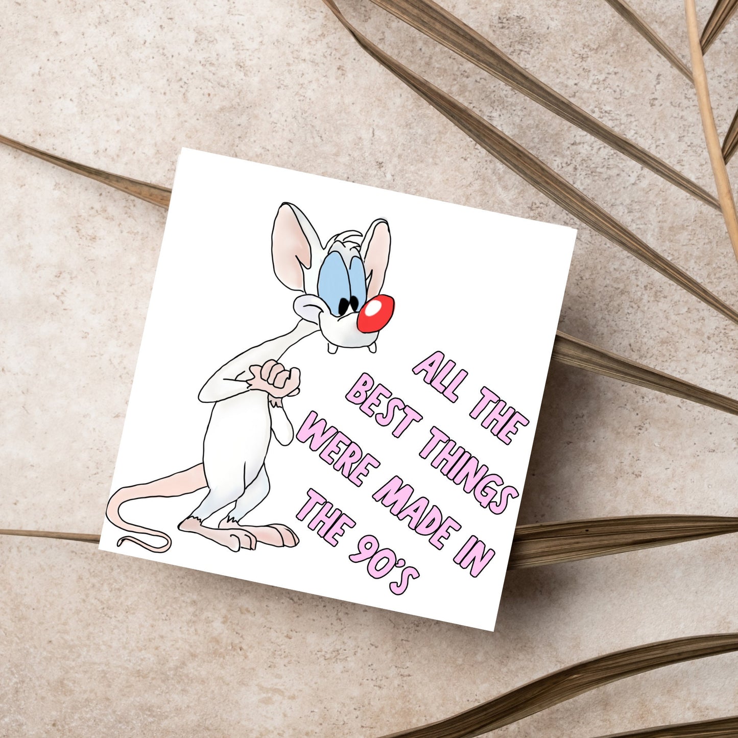 square card featuring an illustration of Pinky from Pinky and the brain with pink text text that reads 'all the best things were' made in the 90's' in the font from the shows title