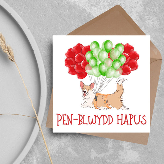 drawing of corgi floating with red and green balloons, welsh birthday