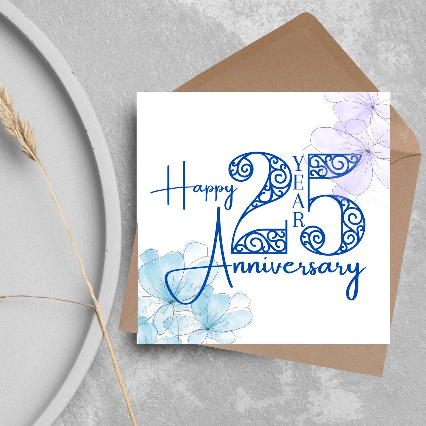Square Card with white background, there are blue faded watercolour flowers on each corner and dark blue text reads 'Happy 25 year anniversary' the words are in a script font and the number is an ornate filigree style