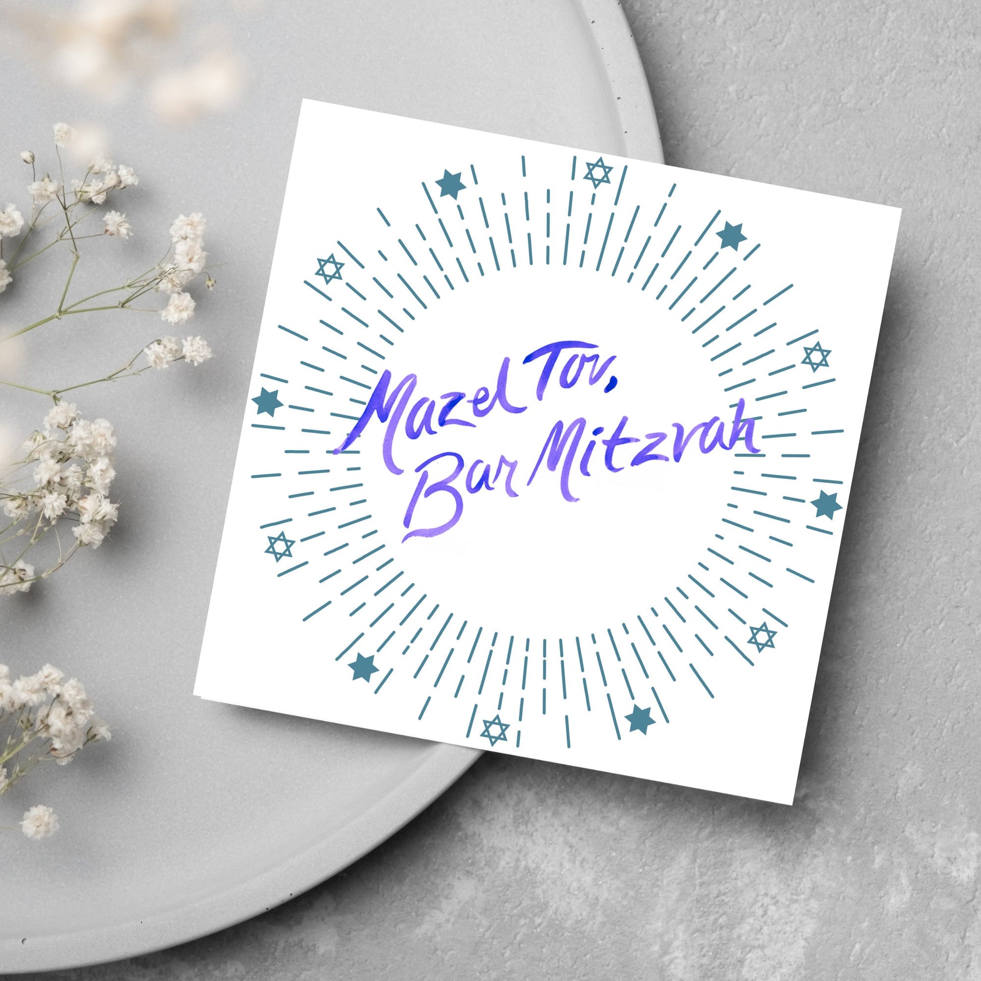 square bar mitzvah card with a white background and the text 'mazel tav, bar mitzvah' in the centre in a blue handwritten script style font. Surrounding the text is a circle made of concentric blue lines and 12 stars of david