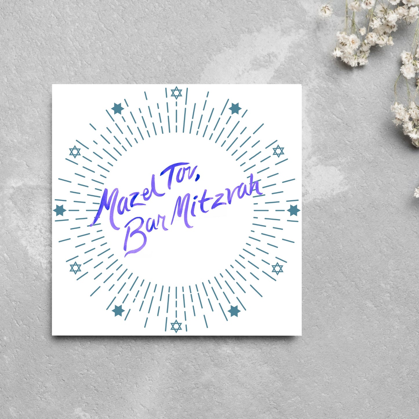 square bar mitzvah card with a white background and the text 'mazel tav, bar mitzvah' in the centre in a blue handwritten script style font. Surrounding the text is a circle made of concentric blue lines and 12 stars of david