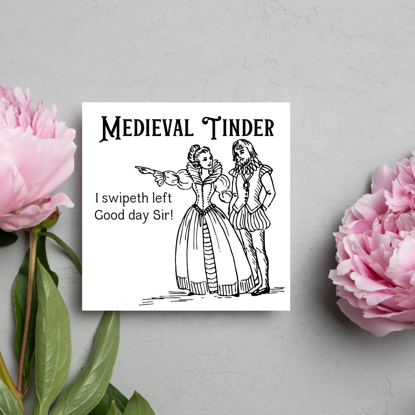 image of a square greetings card with a black and white hand drawn vintage style illustration of medieval man and woman, the woman pointing left and the text - medieval tinder. I swipeth left. Good day Sir! - in a vintage blackletter font