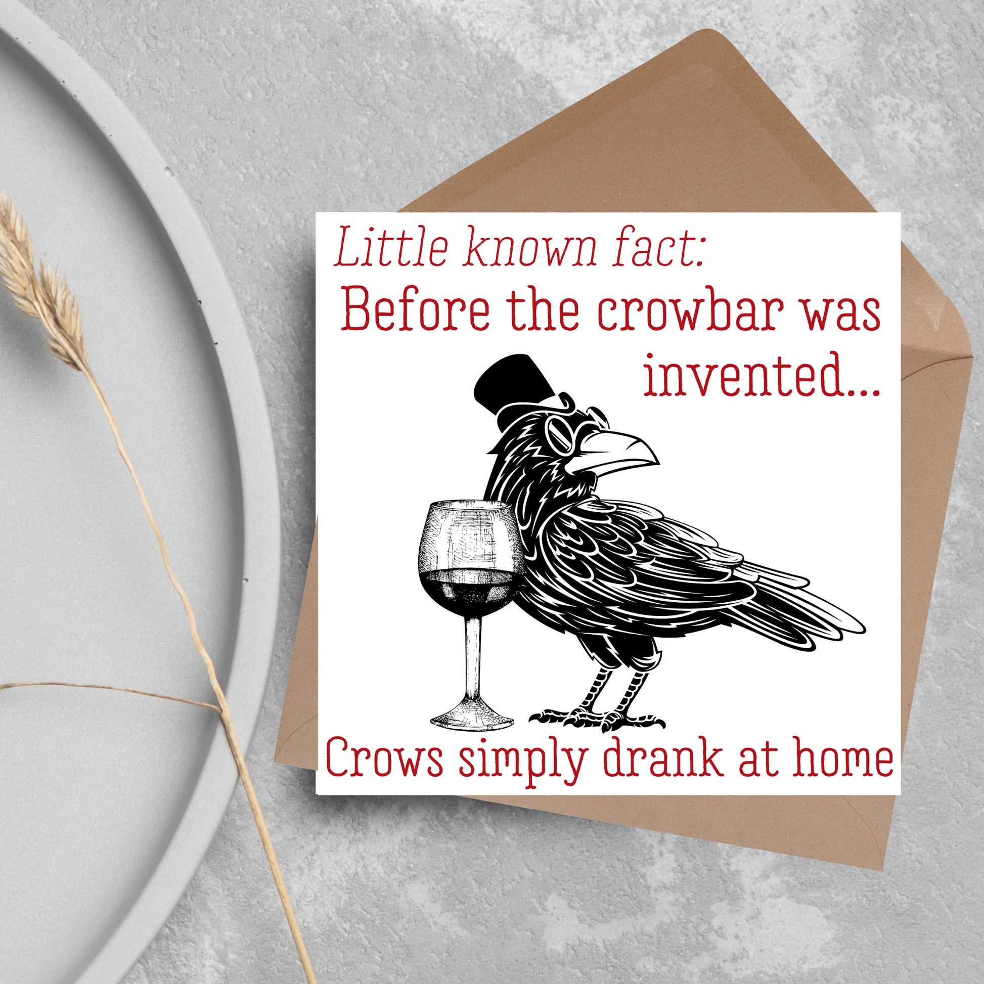 image of a square greetings card with a black and white drawing of a crow wearing a top hat and spectacles, standing next to a half empty glass of wine and the text - little known fact: before the crowbar was invented...crows simply drank at home