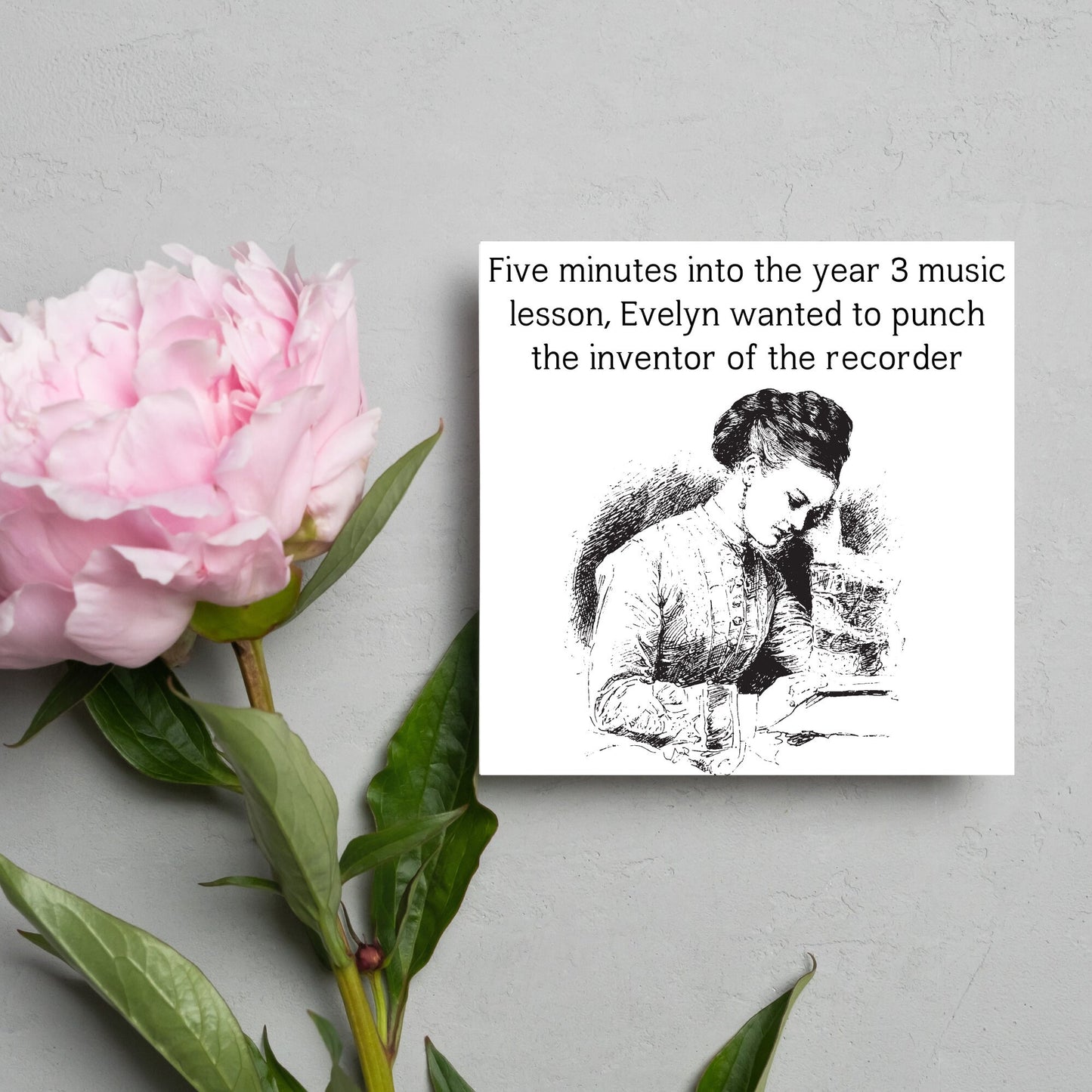 Image of a square greetings card with a black and white line drawing of a victorian lady sitting at a desk with her head in her hands and the text - five minutes into the tear 3 music lesson, evelyn wanted to punch the inventor of the recorder