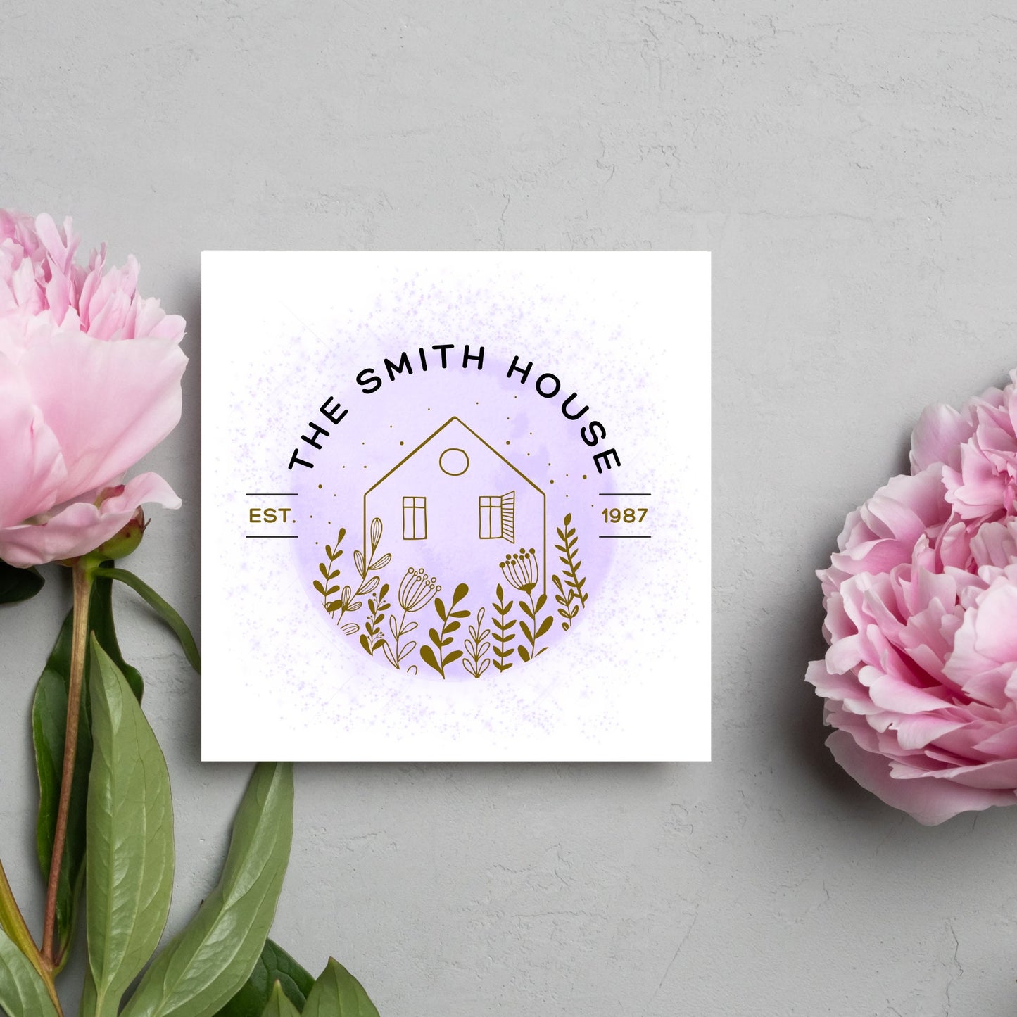 square card with a purple watercolour circle with a line drawing of a house and foliage over it. Arched text reads the smith house on top with est 1987 running through the centre