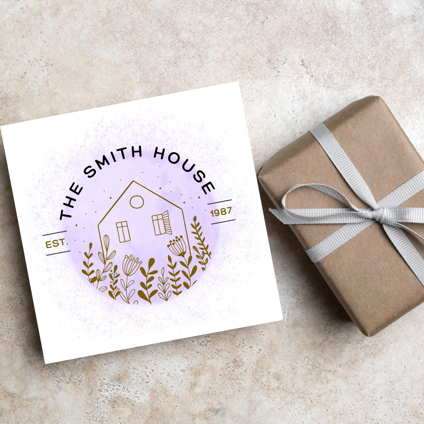 square card with a purple watercolour circle with a line drawing of a house and foliage over it. Arched text reads the smith house on top with est 1987 running through the centre