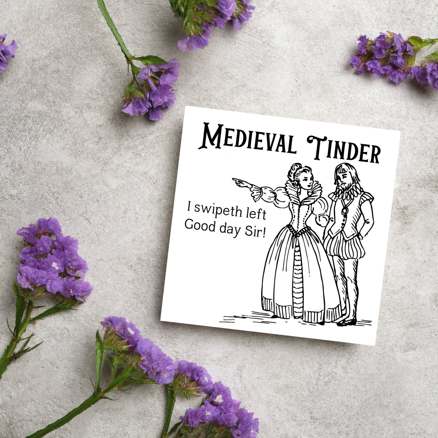 image of a square greetings card with a black and white hand drawn vintage style illustration of medieval man and woman, the woman pointing left and the text - medieval tinder. I swipeth left. Good day Sir! - in a vintage blackletter font
