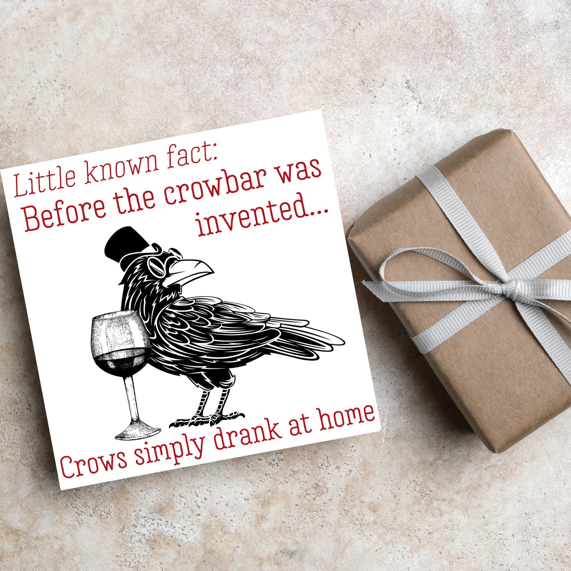 image of a square greetings card with a black and white drawing of a crow wearing a top hat and spectacles, standing next to a half empty glass of wine and the text - little known fact: before the crowbar was invented...crows simply drank at home