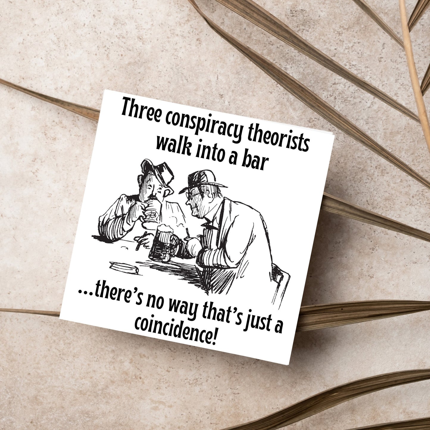 Image of a square greetings card with a hand drawn black and white line cartoon sketch of two old men at a bar drinking beer with the text- 3 conspiracy theorists walk into a bar....there's no way that's just a coincidence!