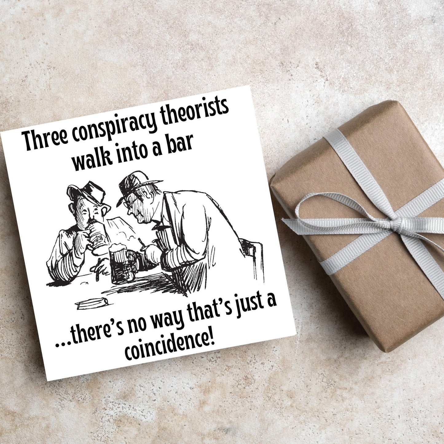 Image of a square greetings card with a hand drawn black and white line cartoon sketch of two old men at a bar drinking beer with the text- 3 conspiracy theorists walk into a bar....there's no way that's just a coincidence!